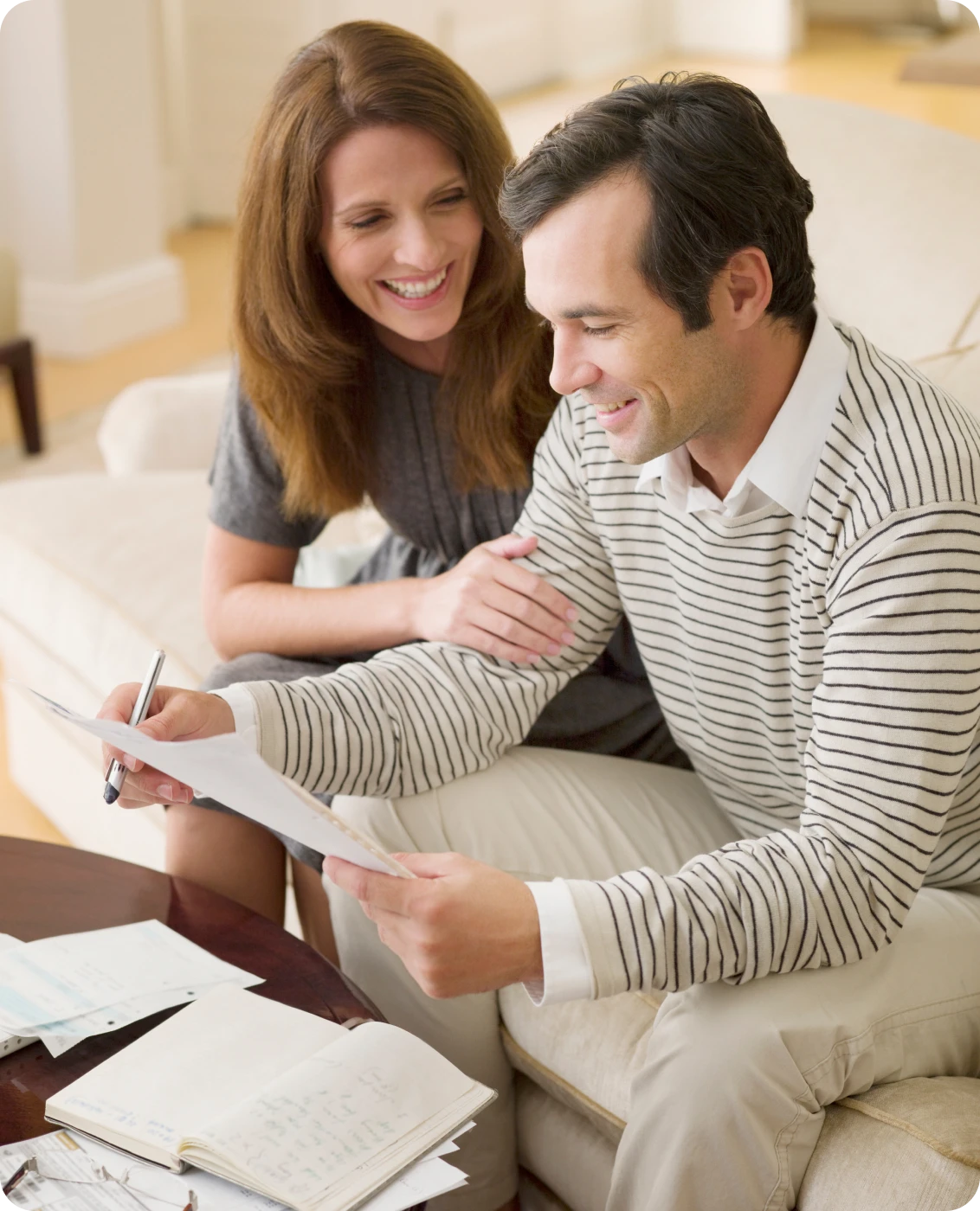 Couple reviewing documents together on couch