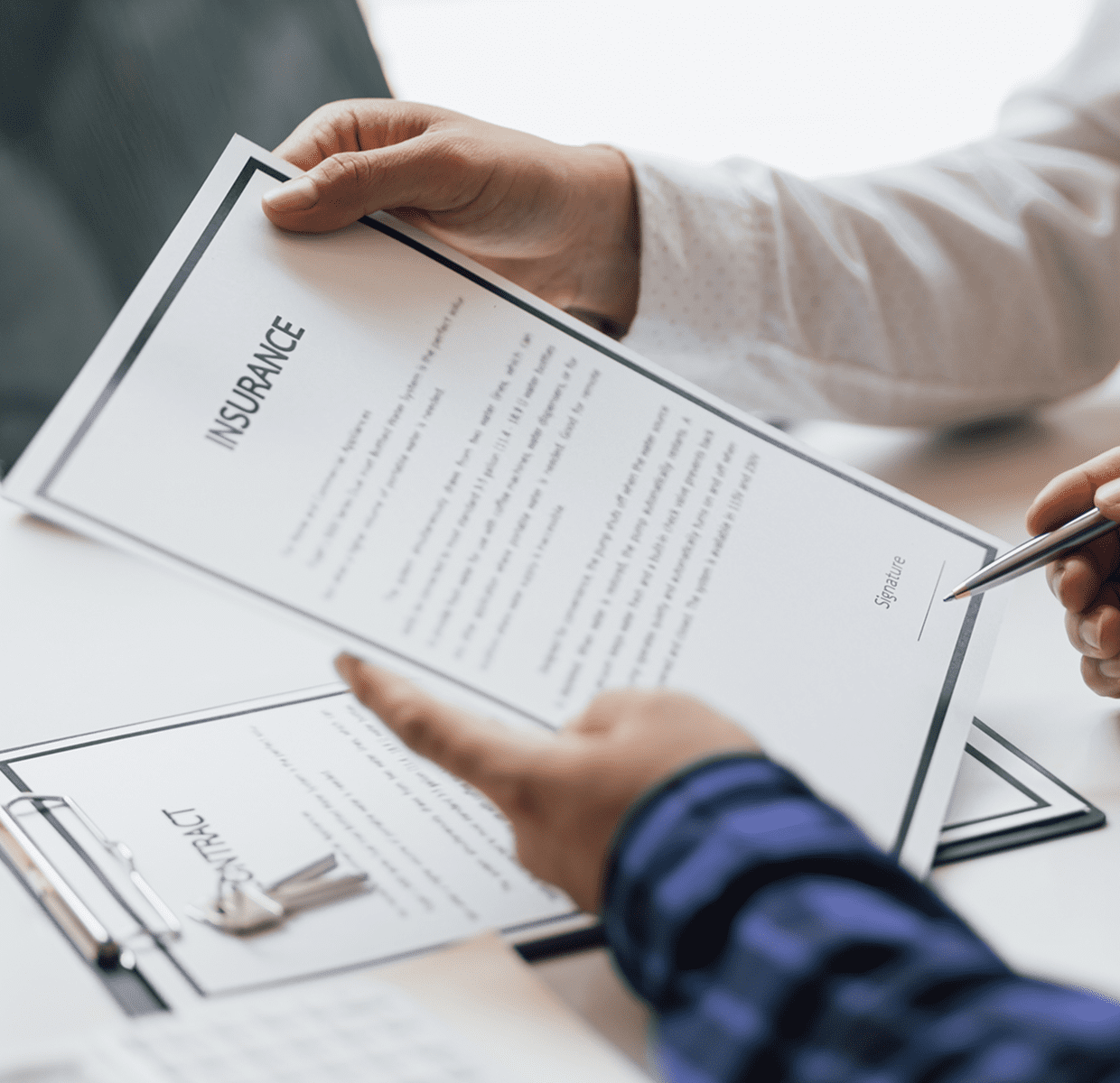 Signing insurance contract at a desk