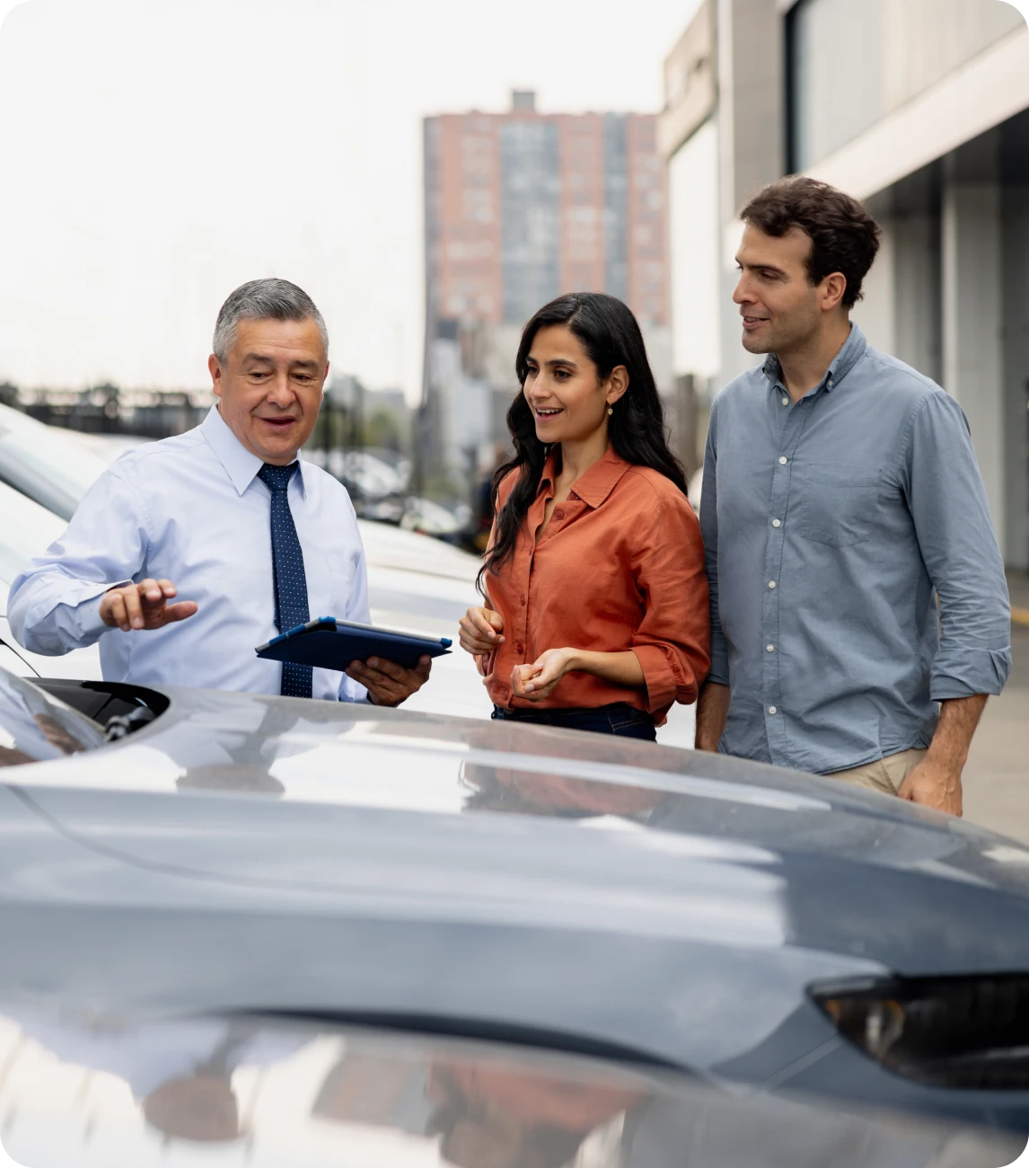 Car dealership discussion with couple