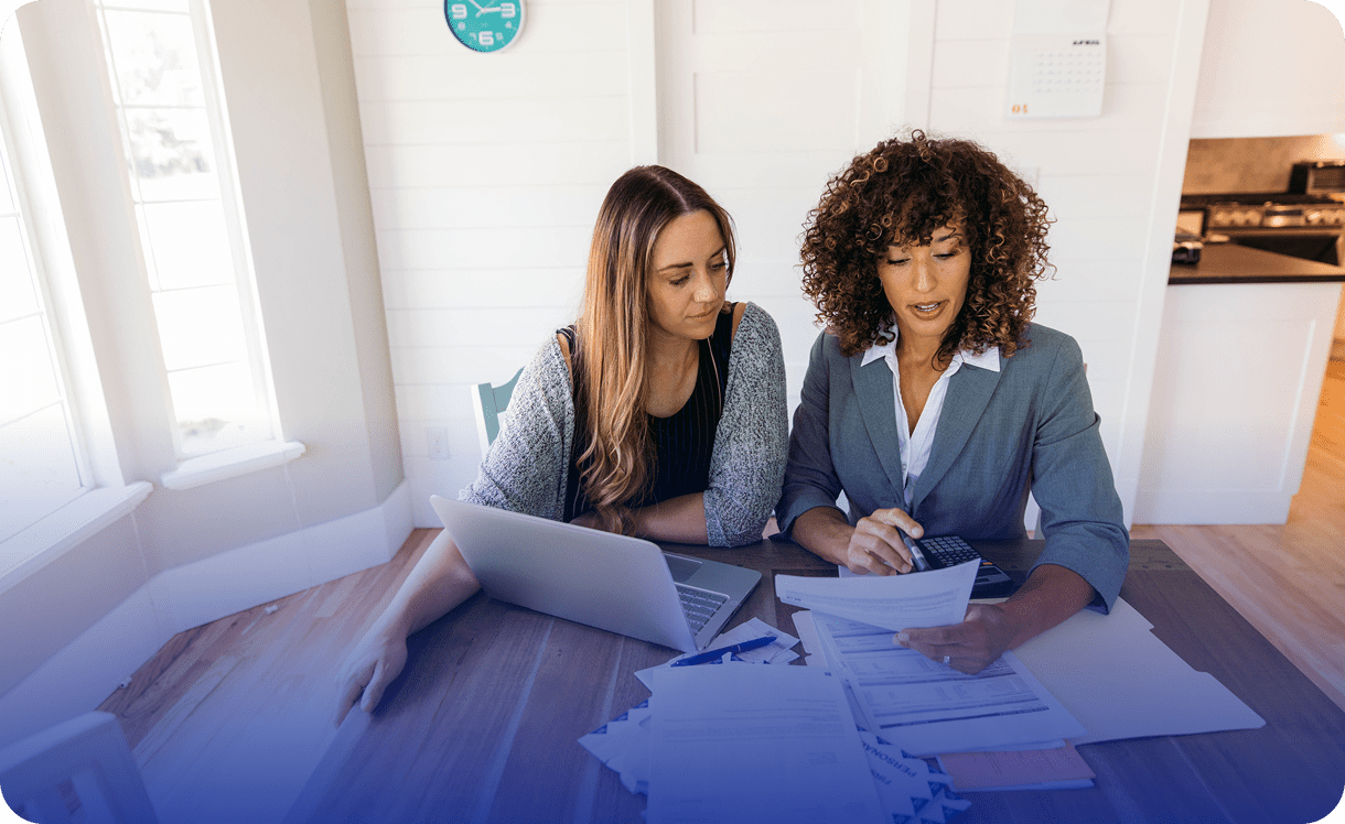 Two women reviewing documents at table
