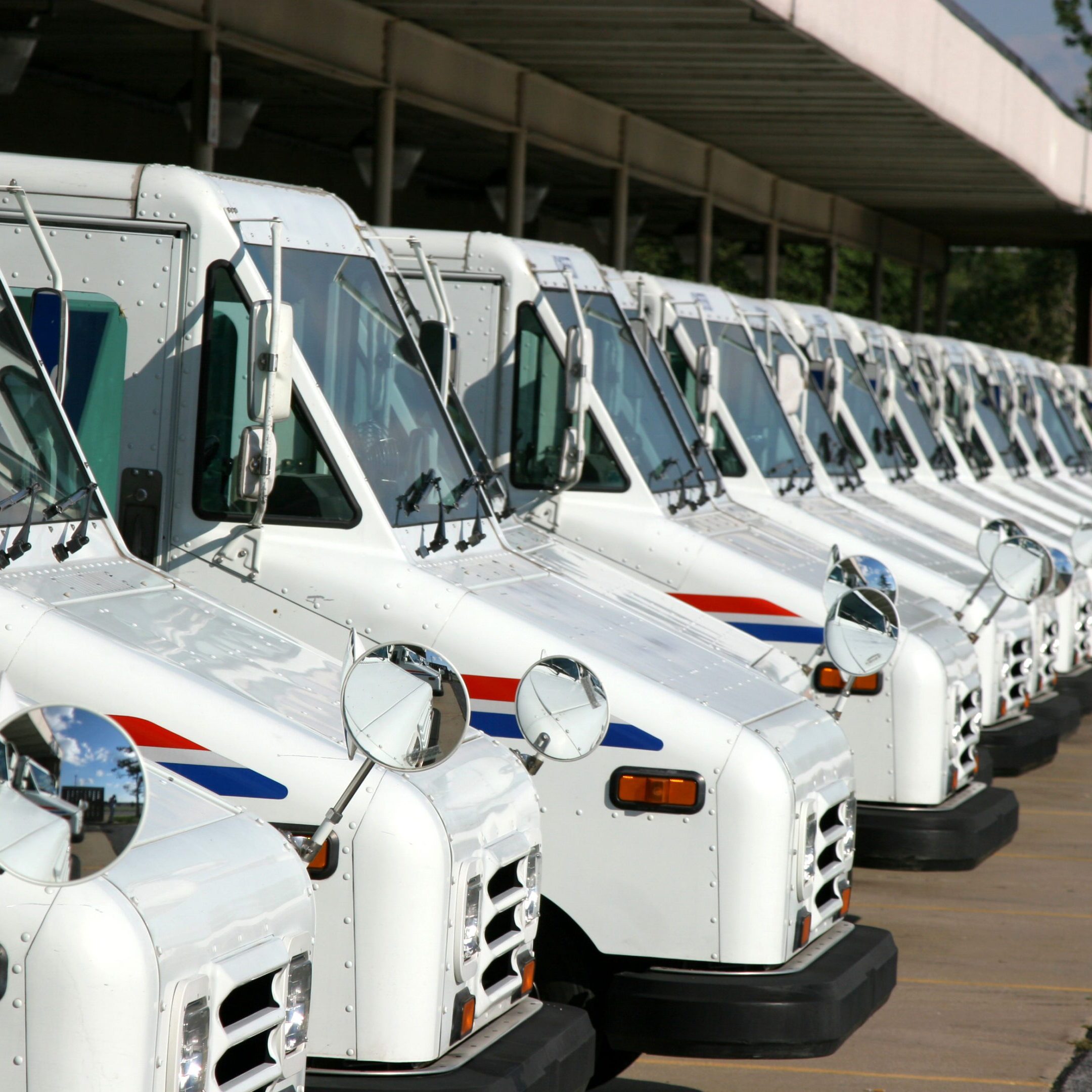 Fleet of white mail delivery vehicles
