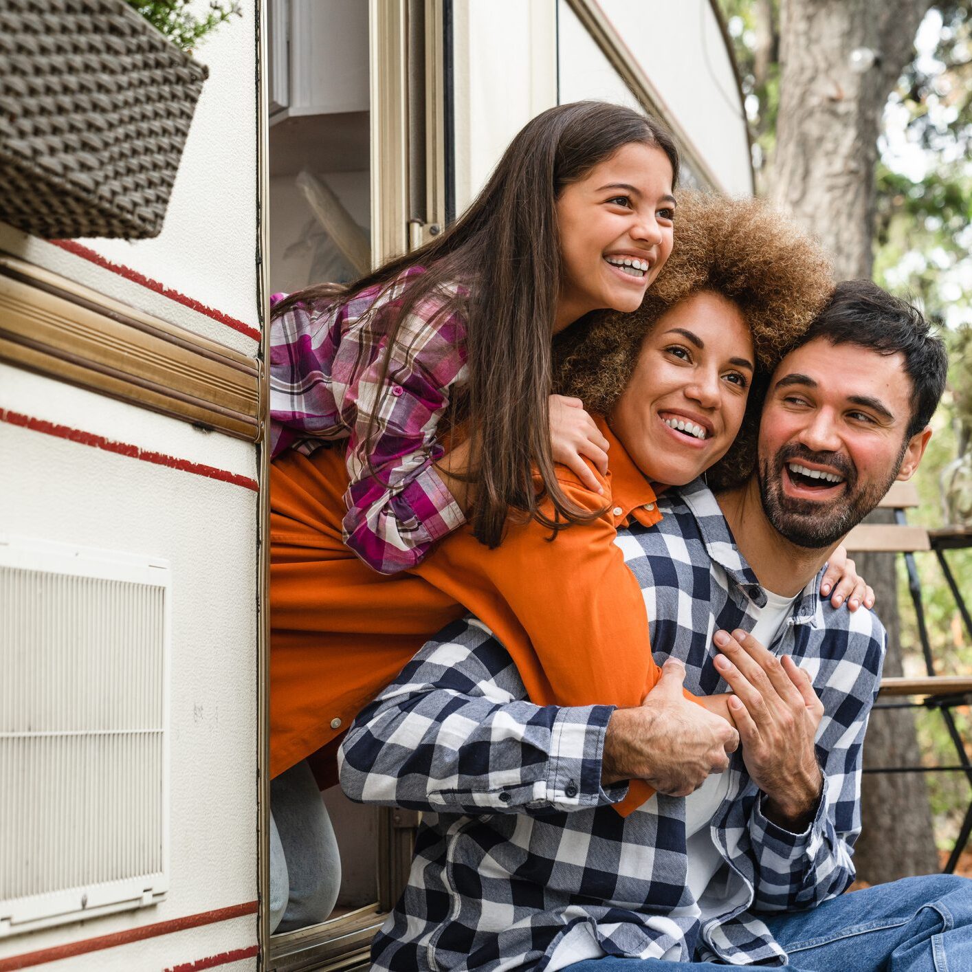 Happy family outside camper van