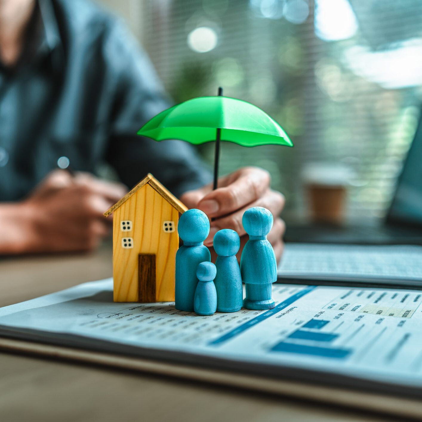 Family insurance concept with house and umbrella